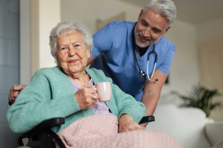 A nurse reviews a medication log with an older adult in a comfortable common room.